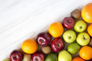 Set of fresh raw fruits on white wooden background. Copy space. Top view. Flat lay.