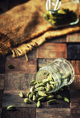 Dry whole cardamom, vintage wooden background, selective focus