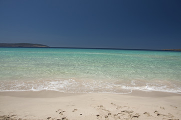 Fototapeta na wymiar Crystal clear waters of exotic Simos beach at Elafonisos island in Greece