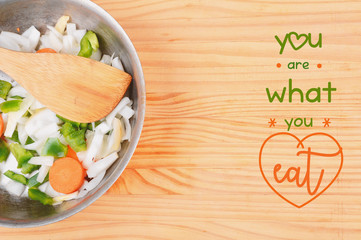 Vegetables and seasonings on wooden table with text