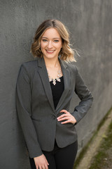buisness woman grey suit arm out