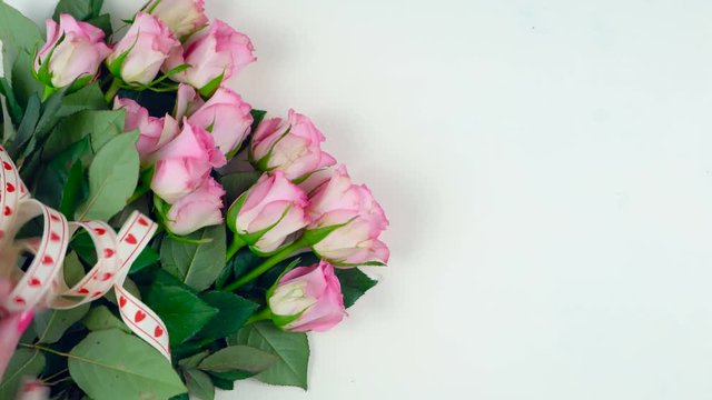 Happy Mother's Day overhead with gift and pink roses on white wood table background time lapse.