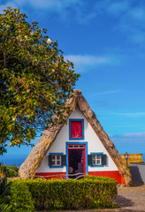 Traditional triangular house in Santana village (vertical photography), in Madeira island of...
