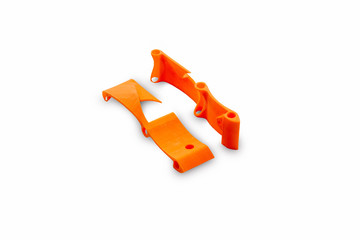 beginning of the racing drone assembly. Elements of a spare part of an unmanned aerial vehicle frame printed on a 3d printer, isolated on a white background