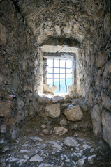 Cage window in ancient tower in Italy