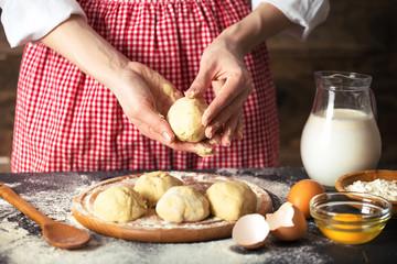 Making dough by female hands at bakery