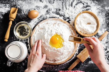 Making dough by female hands at bakery