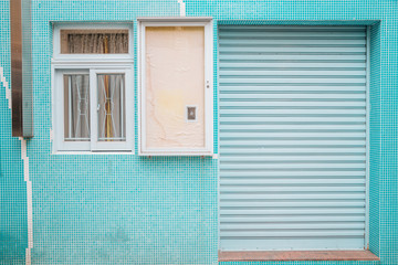 Mint color house wall and shutter door exterior