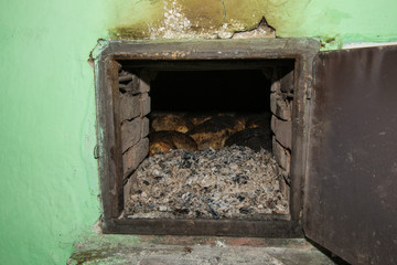 Close-up of vintage and primitive brick bread oven in an European village.