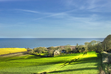 Naklejka premium Scotland landscape. Kinneff Old Church, Aberdeenshire, Scotland, UK. - famous as the site where the Honours of Scotland were hidden after the Siege of Dunnottar Castle