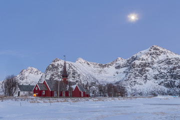 The parish church in Flakstad in the snowy mountains of Lofoten,