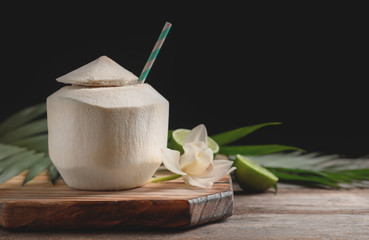 Fresh coconut drink in nut on wooden board © New Africa