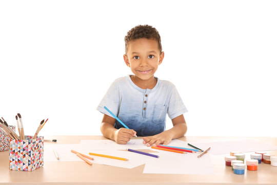 Little African-American boy drawing against white background