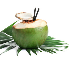 Fresh green coconut with drinking straws and palm leaf on white background