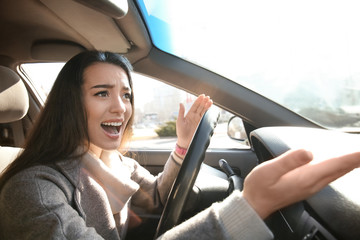 Young woman in car during traffic jam