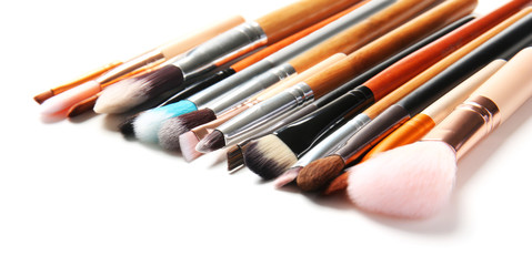 Fototapeta premium Makeup brushes of professional artist on white background