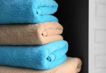 Stack of clean towels on shelf