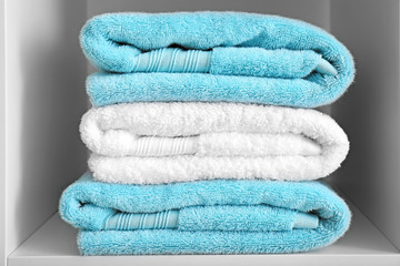 Stack of clean towels on shelf