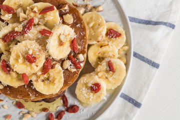Pancakes with banana, walnuts, goji and honey