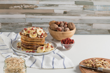 Pancakes with banana, walnuts, goji and honey