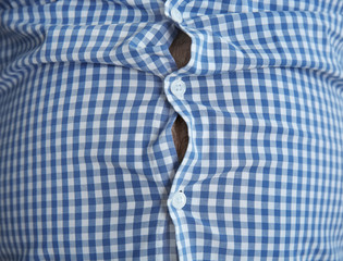 Overweight person in tight clothes, closeup