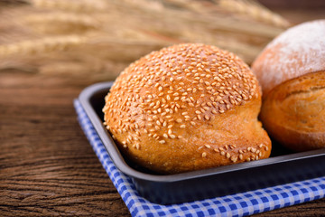 sour dough sesame bread in pan on wooden background
