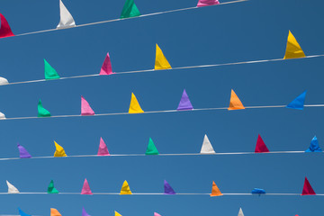 Colorful, triangular bunting on a background of blue sky on a sunny day. - 199369086