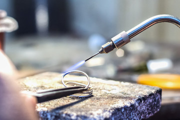 Jeweler using a gas - oxygen welding torch.