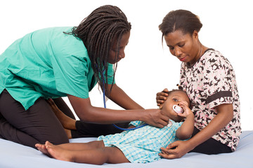 Doctor examining a child patient with stethoscope.