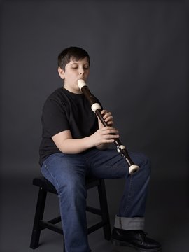 Youth Or Young Boy Learning Or Playing Tenor Recorder For Music Lessons Or Class