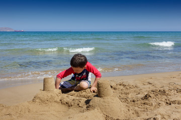 Boy building sand castle at beach