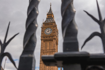 Big ben seen between the bars of parliament