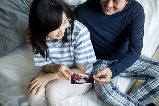 Asian Couple With Baby Ultrasound Photo