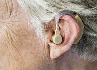 Elderly woman wearing a hearing aid