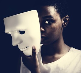 Black woman holding white mask