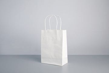 white color paper bag on table