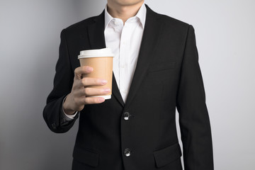 business man holding a paper cup