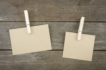 Wooden background with brown paper sheets or note.