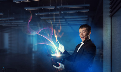 Businessman demonstrating magic . Mixed media