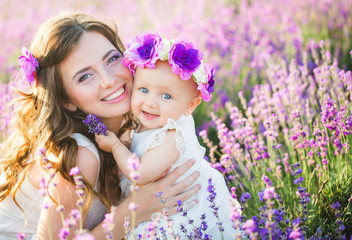 Fototapeta premium Mom and her daughter in a lavender field