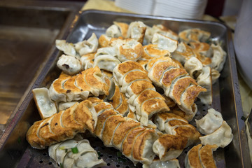 A lot of fried dumpling on the dish