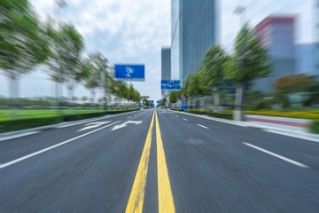 modern asphalt road through modern city skyline