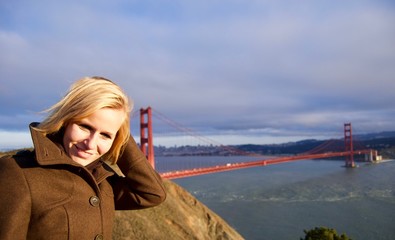 Blonde Woman in front of Golden Gate Bridge, San Francisco - California, USA