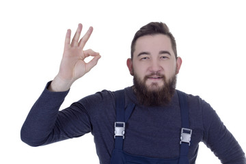 Fototapeta premium Young man with a beard in overalls