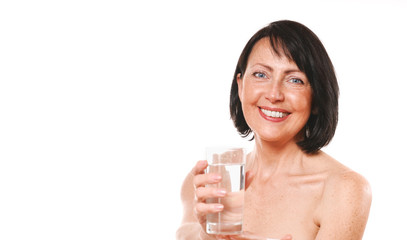 Mature woman hold glass of water