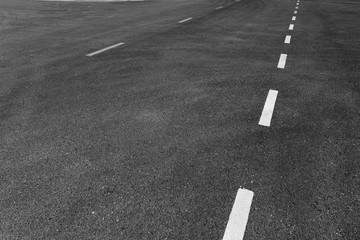 Asphalt road with marking lines white stripes texture Background.