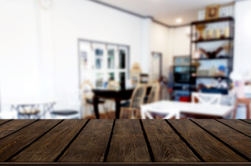 Selected focus empty brown wooden table and Coffee shop or restaurant blur background with bokeh image. for your photomontage or product display.