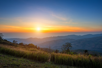 Sunrise Morning at mountain range view on nature trail in Pho lom lo National Park Loei province, Thailand.