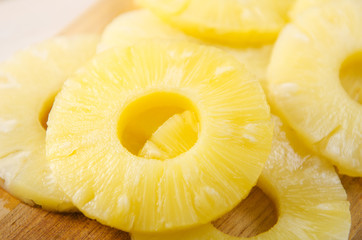 Pieces of pineapple. Pineapple cut into pieces on a wooden cutting board.