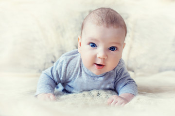 cute baby with blue eyes crawling forward